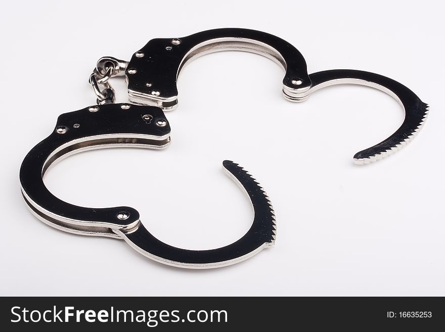 Disclosed iron handcuffs on a white background.