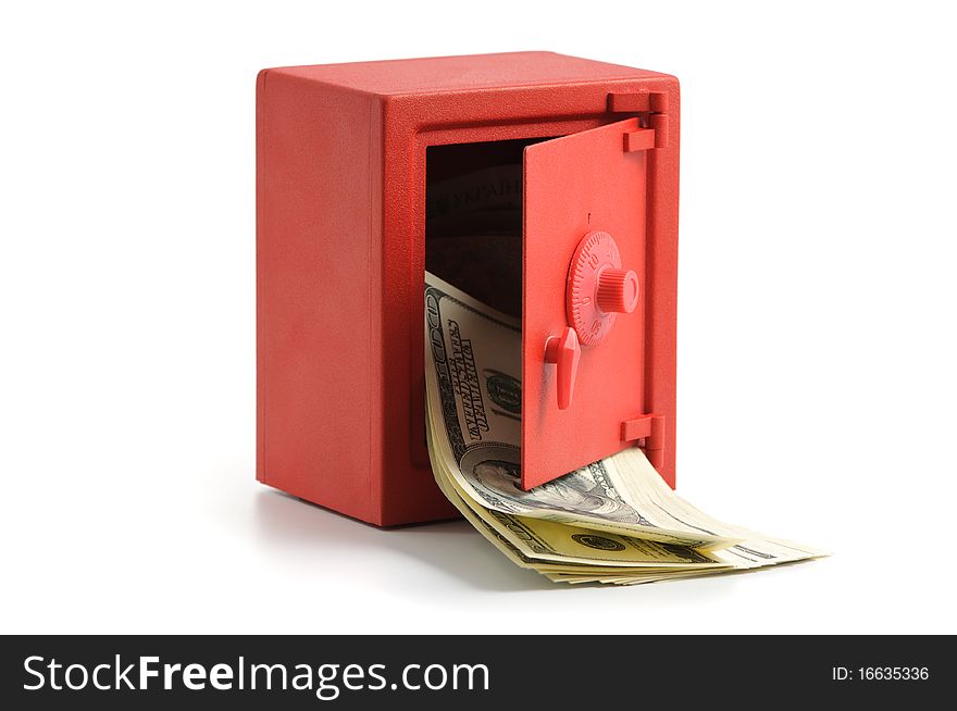 Little red safe with the door open and a stack of dollar bills. Little red safe with the door open and a stack of dollar bills