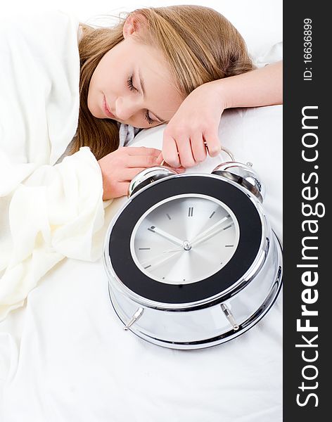 Sleeping girl with an alarm-clock in his hand. Sleeping girl with an alarm-clock in his hand.