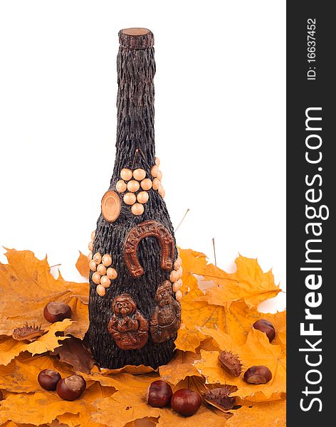 Wooden bottle on the yellow leaves on white background isolated. Wooden bottle on the yellow leaves on white background isolated