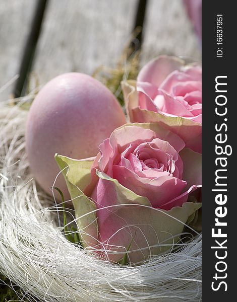 Easter egg in pink with roses in country style close-up