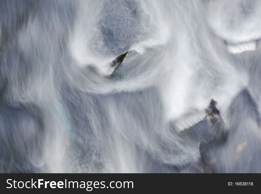 River running down over Stones, Wild Water with Foam and Sp