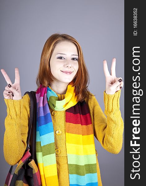 Portrait of red-haired girl in scarf. Studio shot.