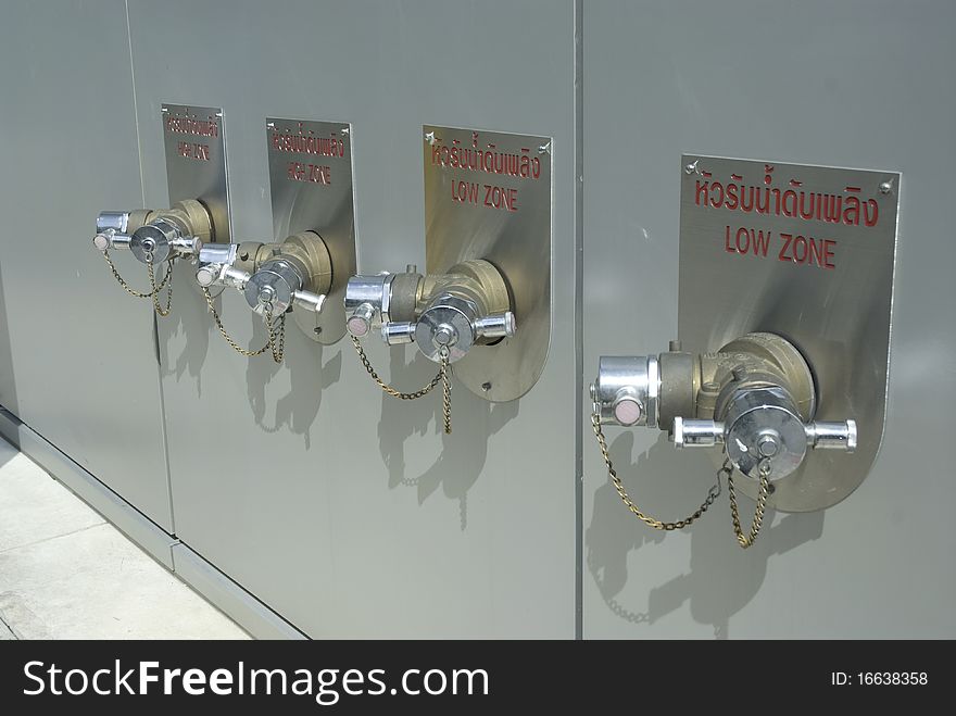 Four fire hydrants on the wall of Modern Building. Four fire hydrants on the wall of Modern Building.