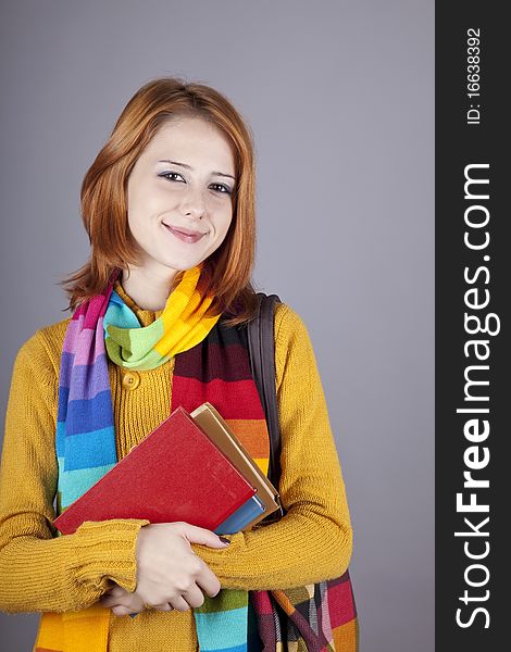 Young student girl with books. Studio shot.