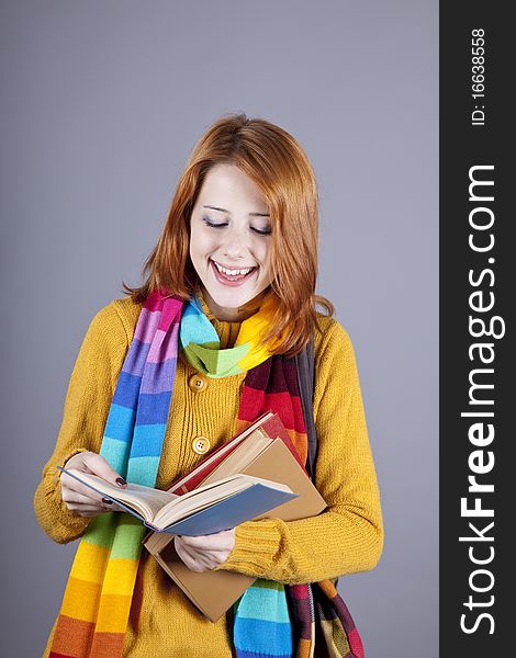 Young student girl with books. Studio shot.