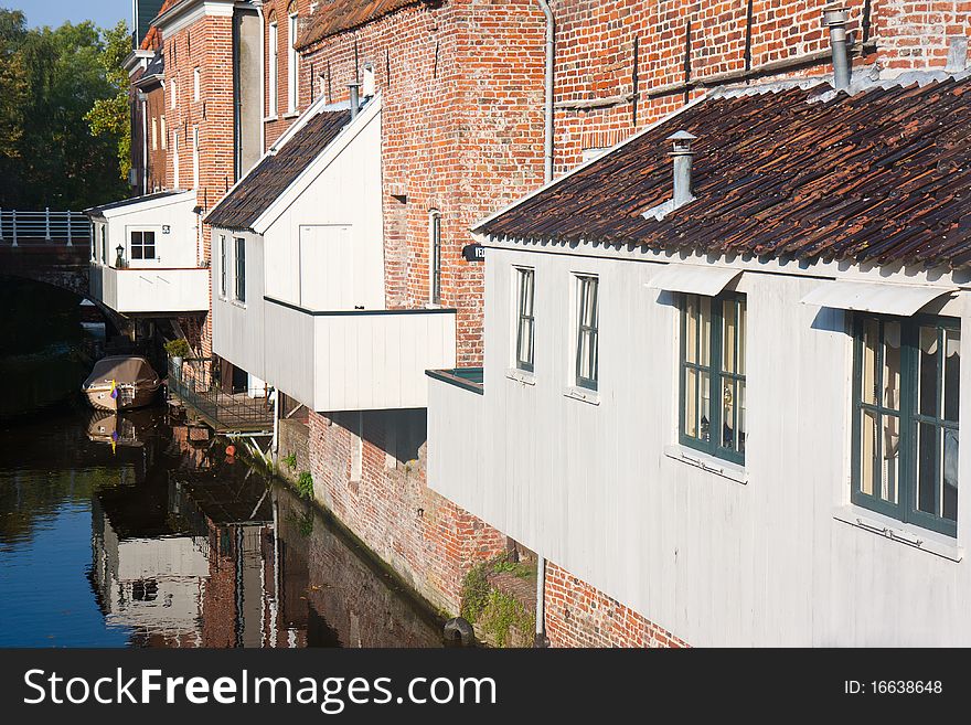 Historic old Dutch city with wooden house extensions above the canal. Historic old Dutch city with wooden house extensions above the canal