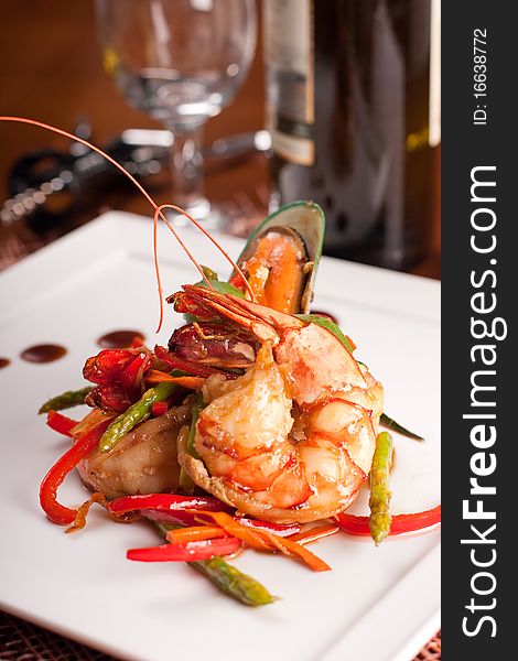 Delicatessen dish with tiger shrimps, mussels and vegetables. Delicatessen dish with tiger shrimps, mussels and vegetables