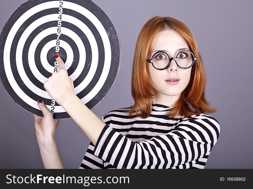 Red-haired girl with dartboard.
