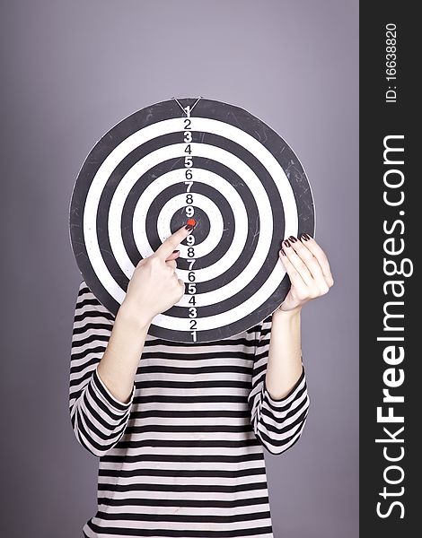 Girl with dartboard in place of head.