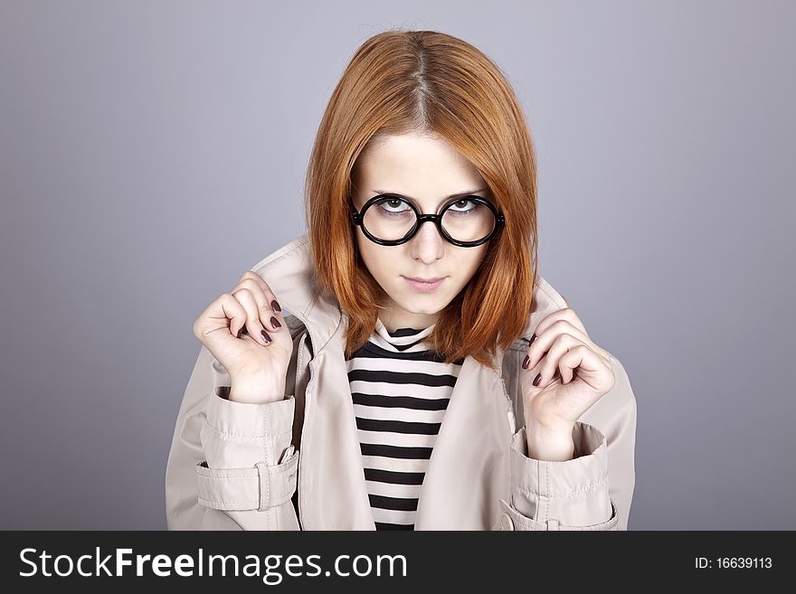 Young Red-haired Girl In Glasses And Cloak.