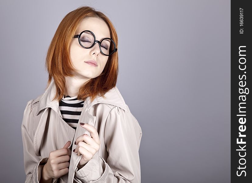Young Red-haired Girl In Glasses And Cloak.