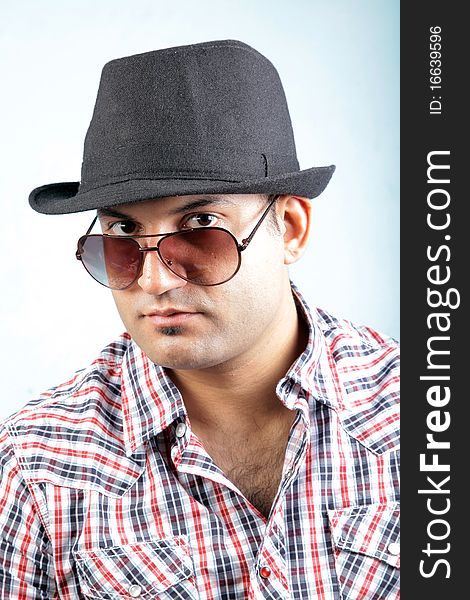 A young male fashion model wearing a black hat and goggles. A young male fashion model wearing a black hat and goggles.