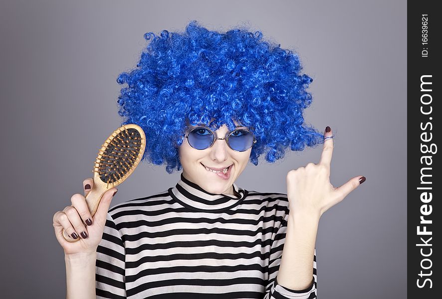 Coquette blue-hair girl with comb. Studio shot.