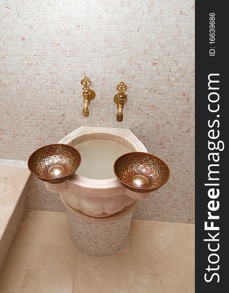 Faucets and two copper bowls in turkish bath. Faucets and two copper bowls in turkish bath