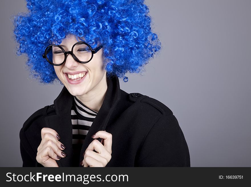 Funny blue-hair girl in glasses and black coat.