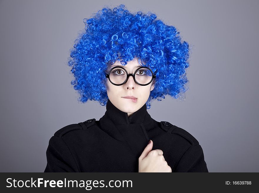 Funny blue-hair girl in glasses and black coat.