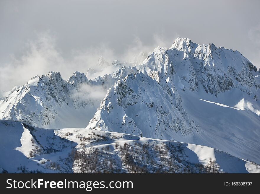 Snowy high mountain peak above the clouds. Snowy high mountain peak above the clouds