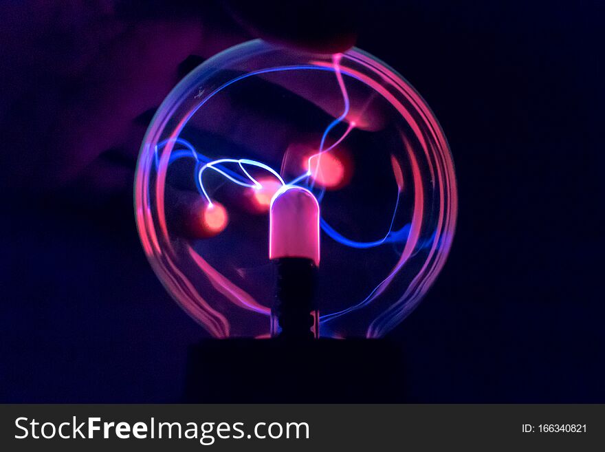 Attraction Of Charge To The Fingers On A Ball Of A Tesla Coil. Statics