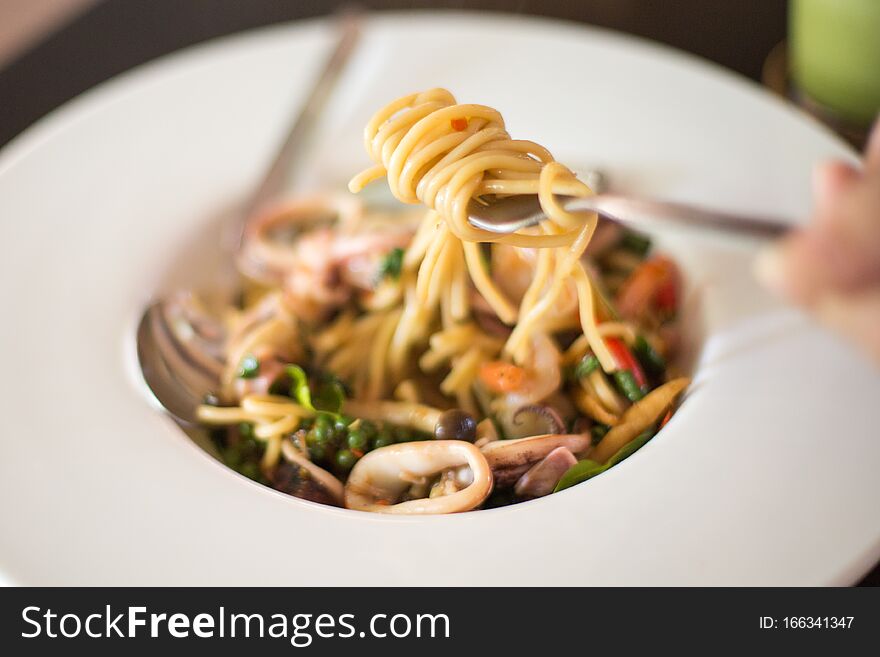 Selective focus of Seafood spaghetti in  a white plate