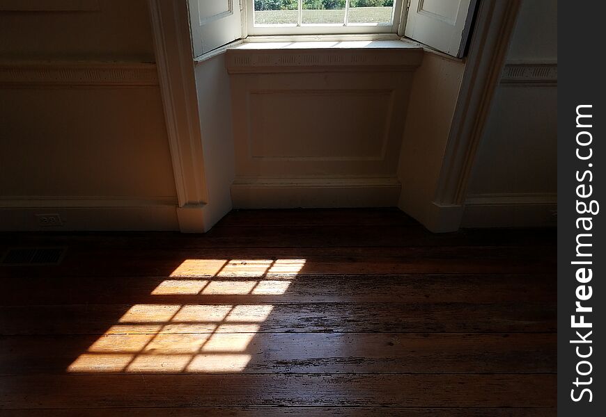 Light from glass window shining on wood floor. Light from glass window shining on wood floor