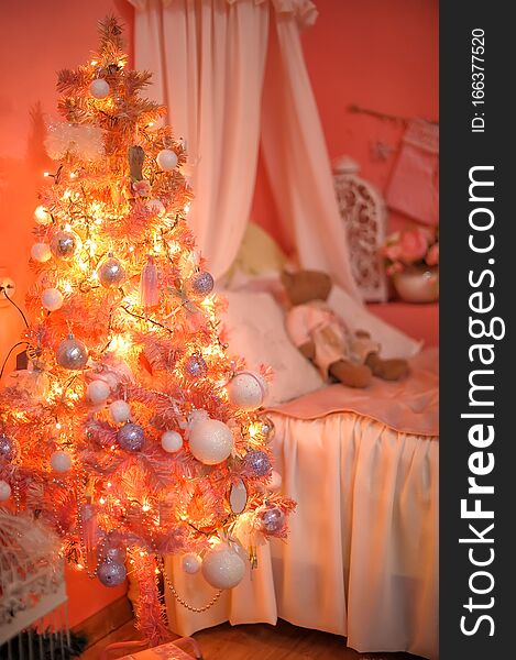 Luminous christmas orange with pink christmas tree in the interior