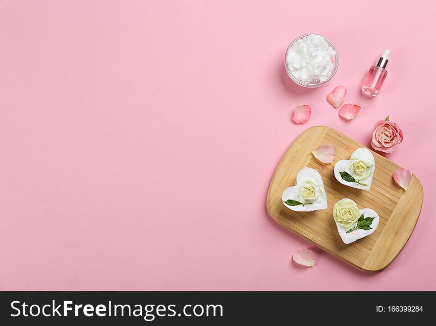 Flat lay composition with handmade soap and ingredients on pink background. Space for text