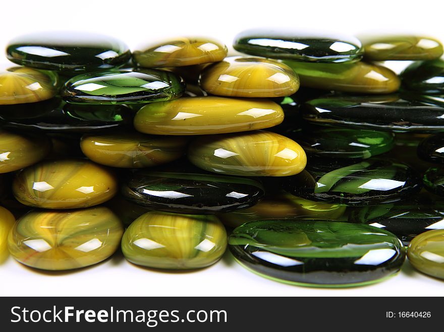 Green and yellow decorative stones on white background. Green and yellow decorative stones on white background