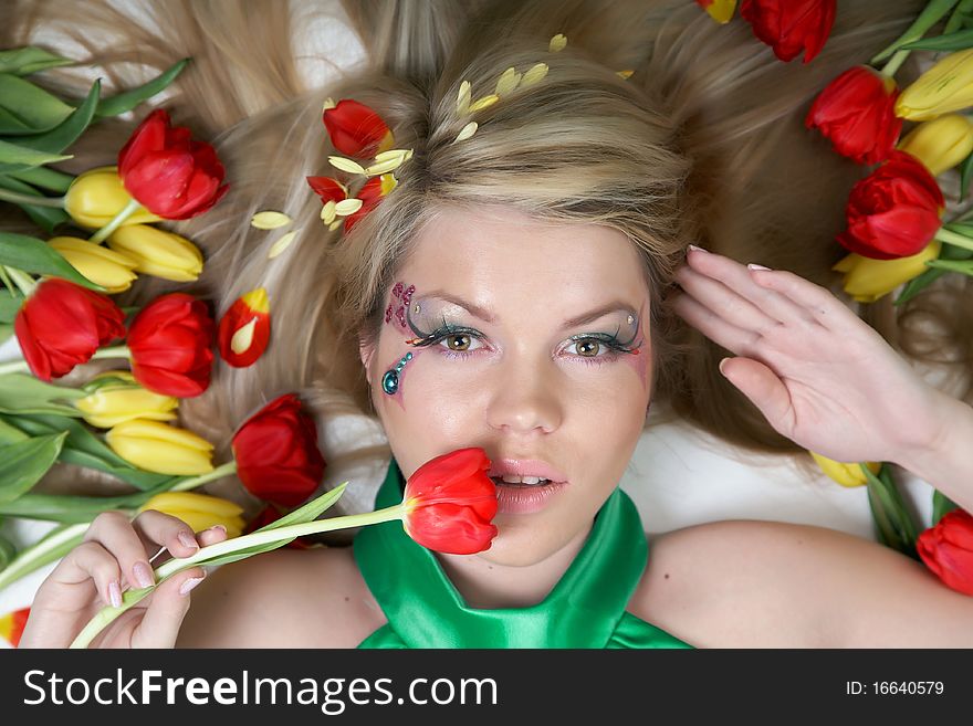 Happy young woman with tulips around. Happy young woman with tulips around
