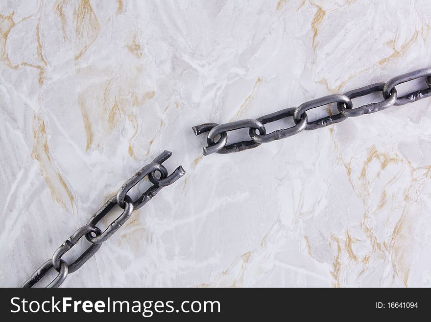 Broken chain over marble texture background