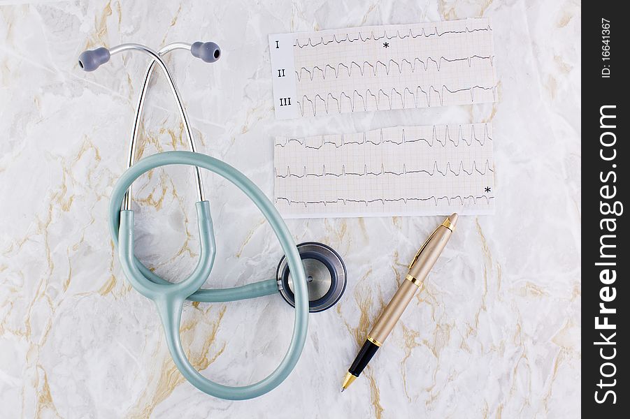 Marble texture background with stethoscope or phonendoscope ECG electrocardiogram graph and elegant pen. Marble texture background with stethoscope or phonendoscope ECG electrocardiogram graph and elegant pen