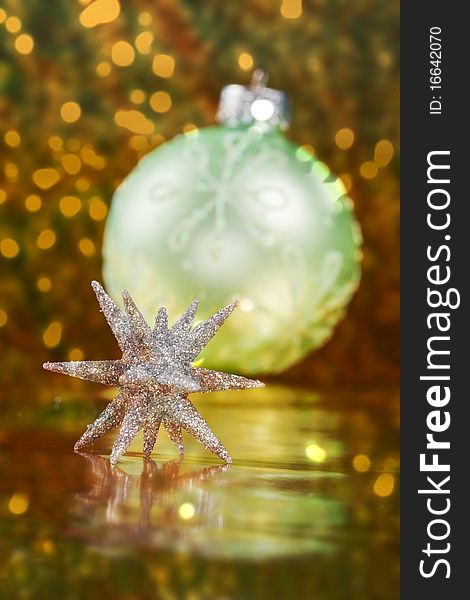 Christmas border of a 3d glitter Christmas star with a light green ornament and lights in the background. Christmas border of a 3d glitter Christmas star with a light green ornament and lights in the background.