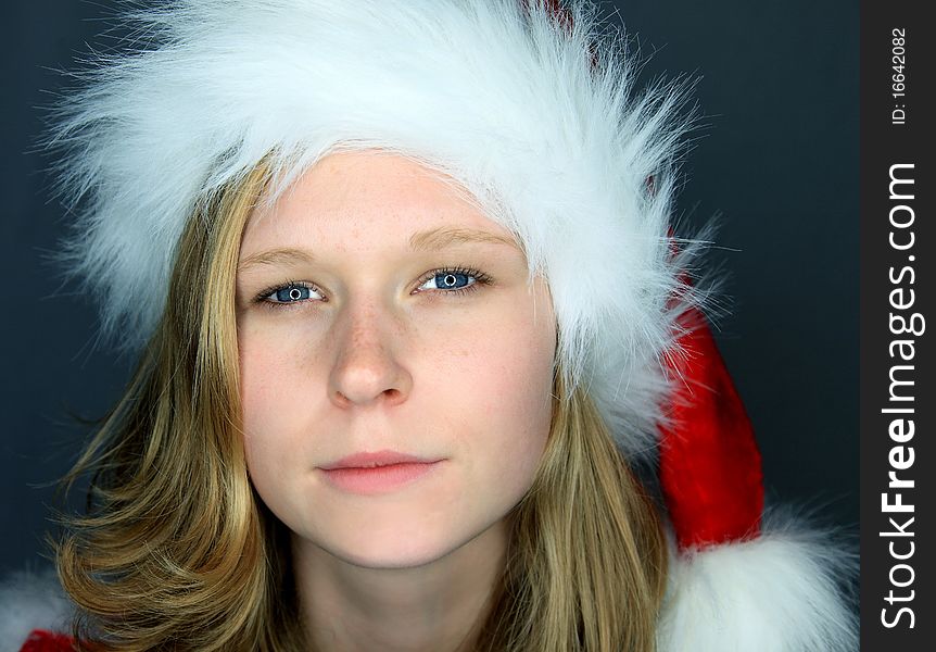 Portrait of a young beautiful woman in a santa claus costume - moody atmosphere. Portrait of a young beautiful woman in a santa claus costume - moody atmosphere