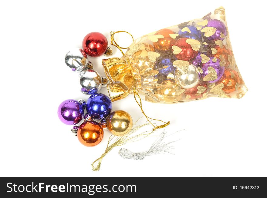Christmas colorful balls in golden bag, on white. Christmas colorful balls in golden bag, on white