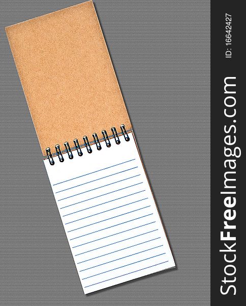 Notebook on textured background, blank for your text. Notebook on textured background, blank for your text.