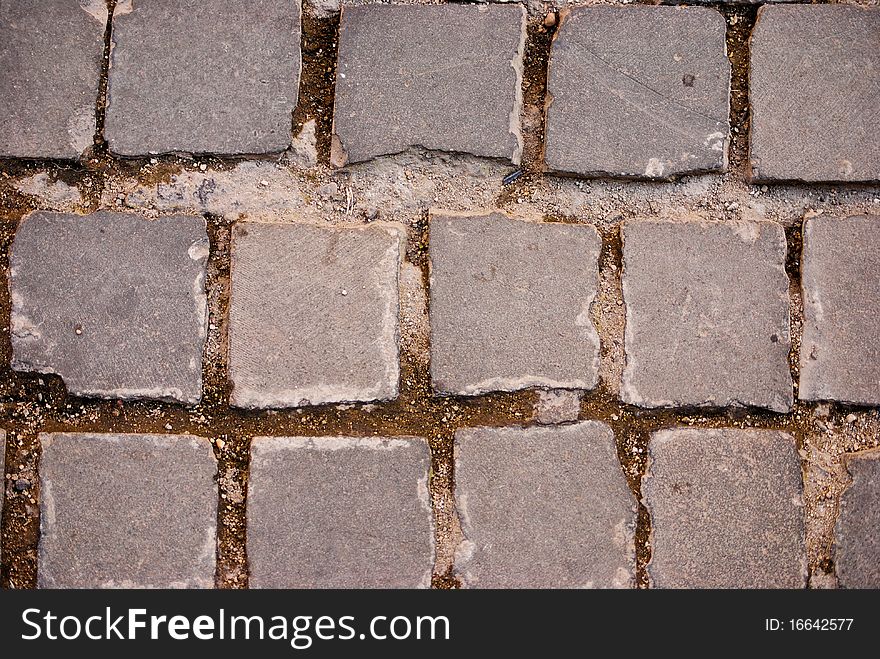 Grey square tiles of pavement forming a pattern. Grey square tiles of pavement forming a pattern