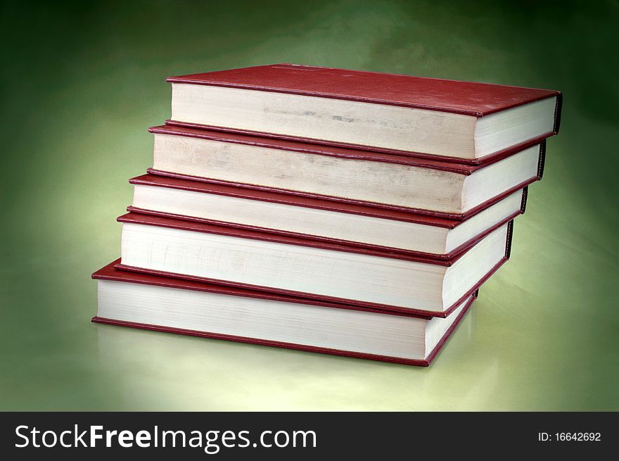 Set of redish orange old books on studio background with copy space