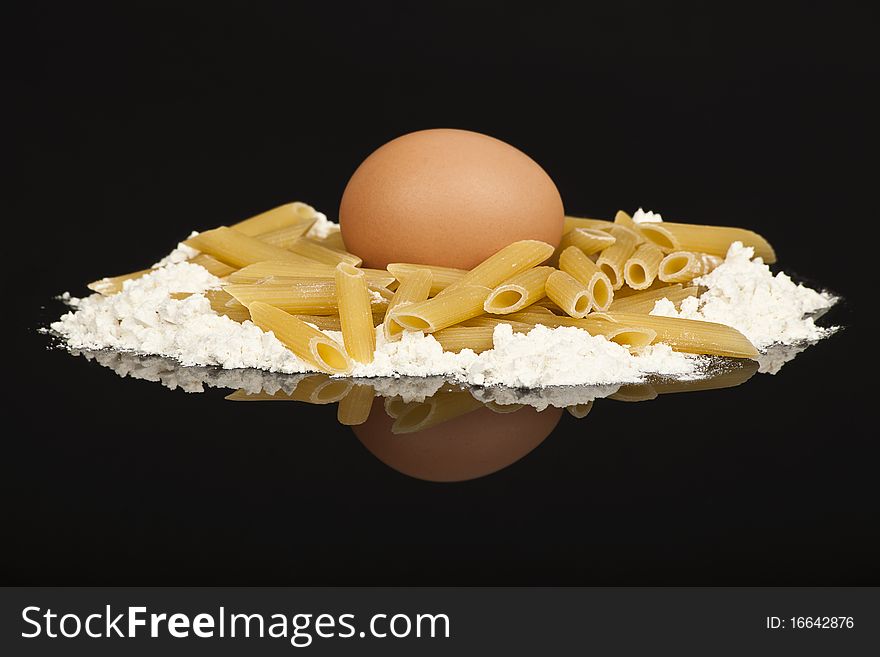 Flour and pasta formed into the nest for the egg. Flour and pasta formed into the nest for the egg