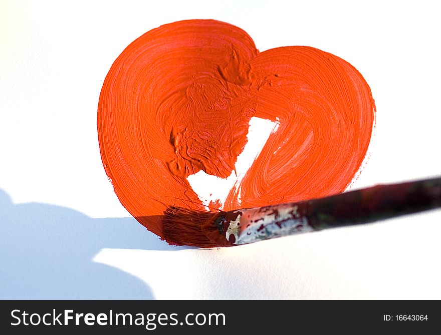 Painting a red heart with the paintbrush