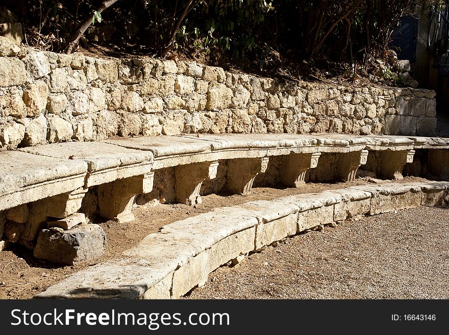 Ancient stone benches in a courtyard