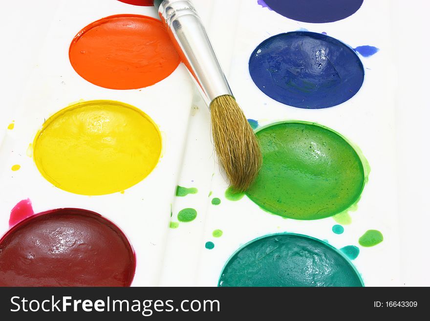 Dirty watercolor paints set with brushes after using. Dirty watercolor paints set with brushes after using