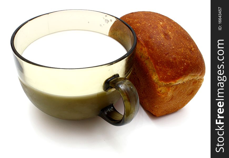 Black bread with milk in a mug on the white isolated background