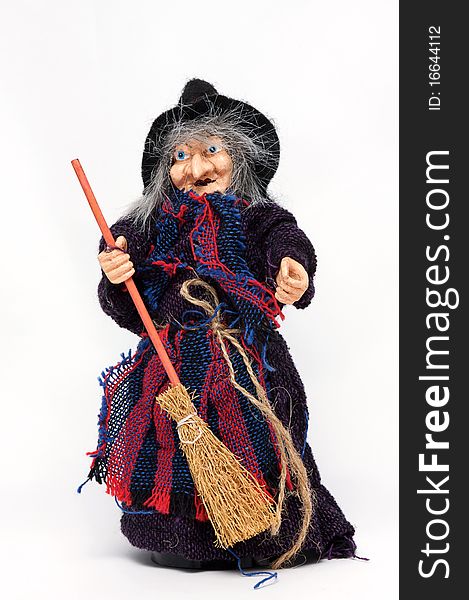 Old Halloween witch with broomstick and hat isolated on white background