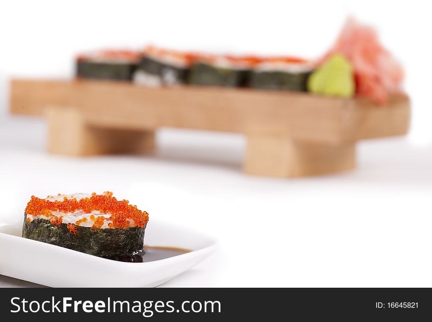 Sushi Topped with red caviar against Red sushi  Dragon on a wooden board over white background