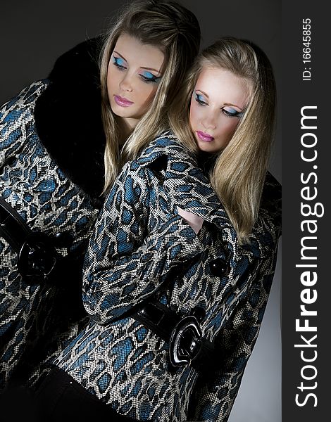 Two young women in jackets with snakeskin texture