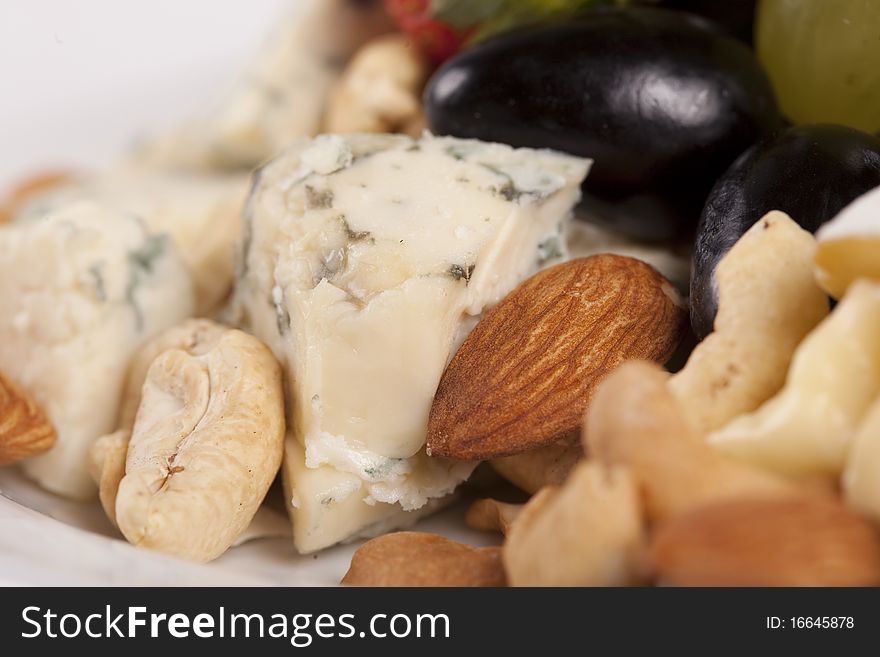Close up of cheese plate with grapes and nuts