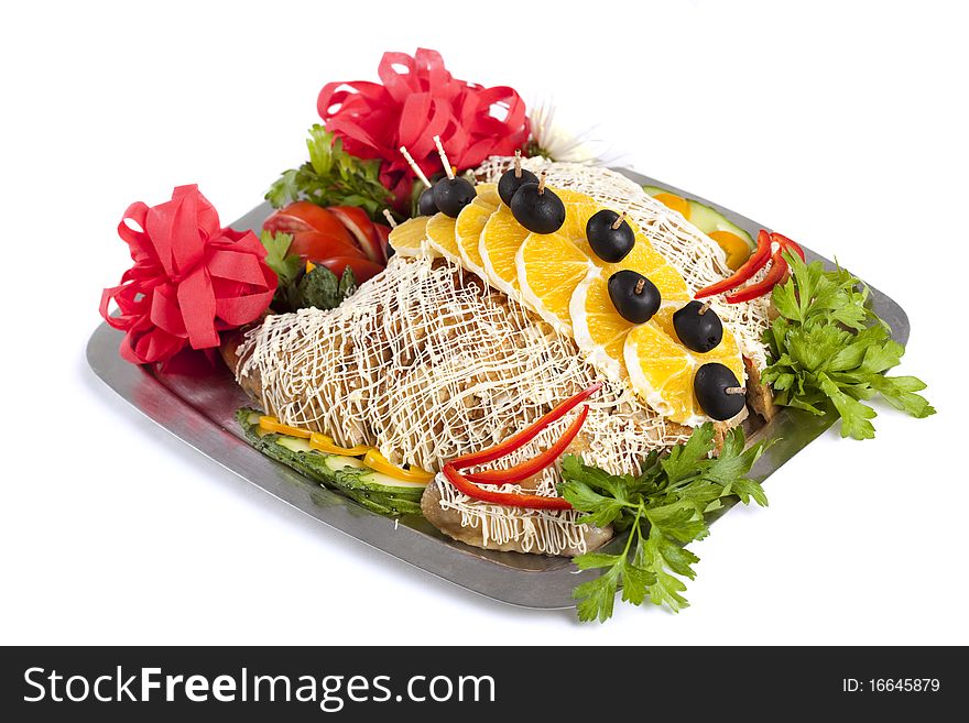 Baked stuffed chicken decorated with slice oranges and olives on skewers over white bacground. Baked stuffed chicken decorated with slice oranges and olives on skewers over white bacground