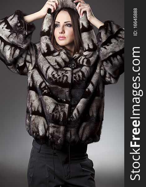 Attractive woman in fu rsheepskin jacket with hood. Attractive woman in fu rsheepskin jacket with hood