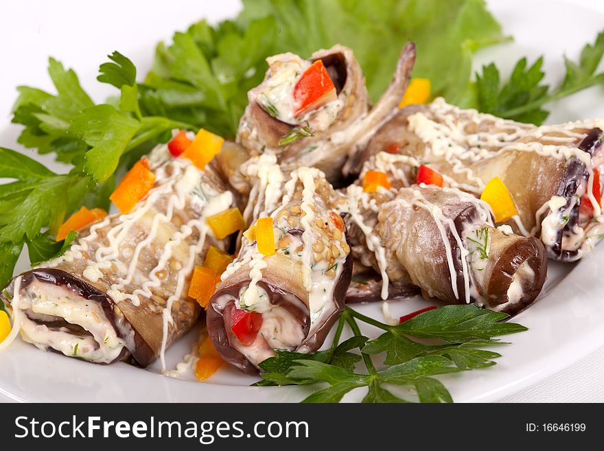 Baked Eggplant rolls stuffed Tomato and Dressed with Parsley. Over white background