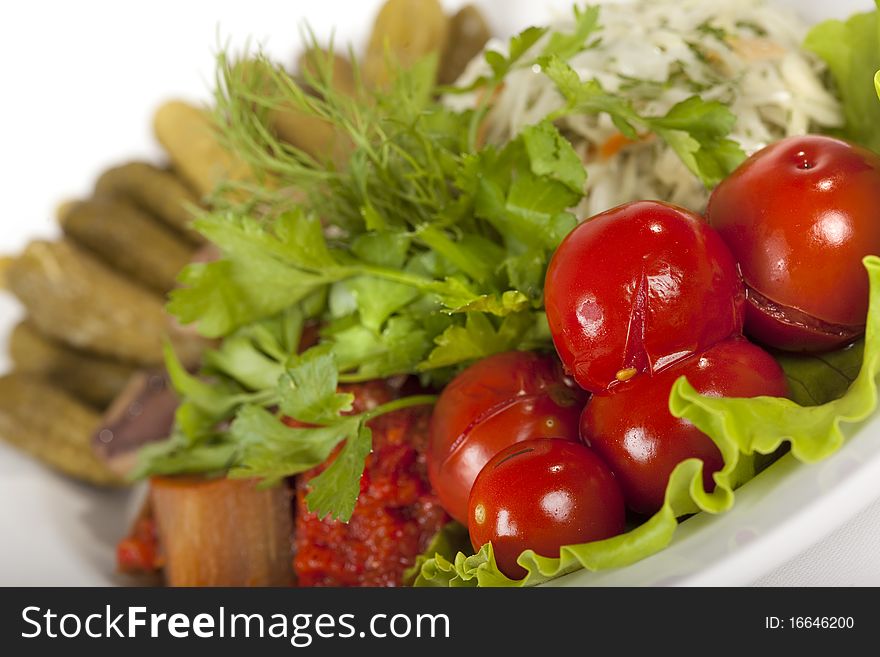 Marinated vegetables at the plate isolated on a white background